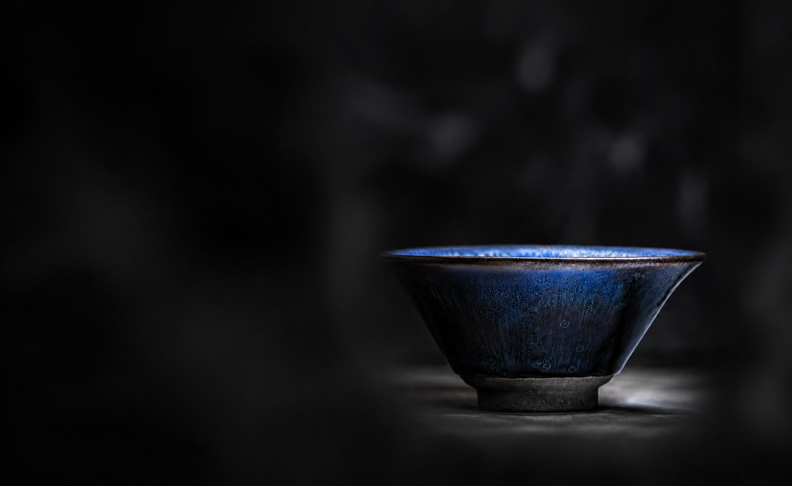 A deep blue Japanese bowl in quiet shadow